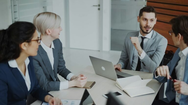 Clio vs MyCase: a small law firm team comparing practice management software at a desk