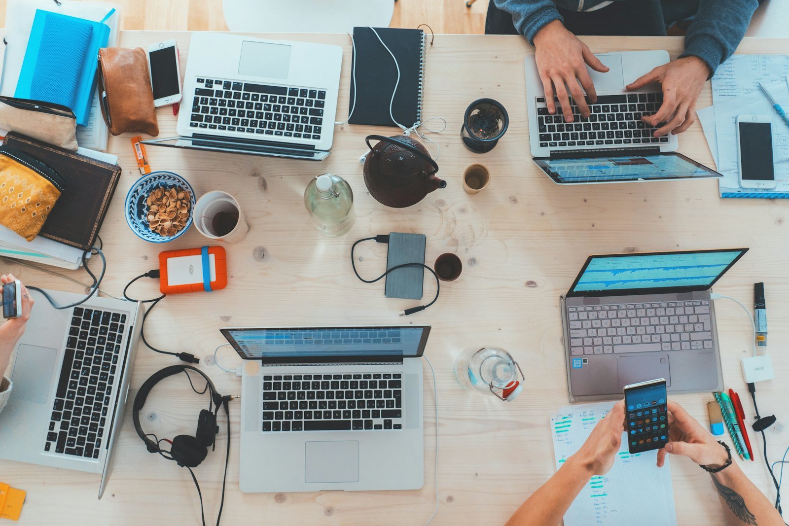 Photography client questionnaire: a team reviewing client details on laptops