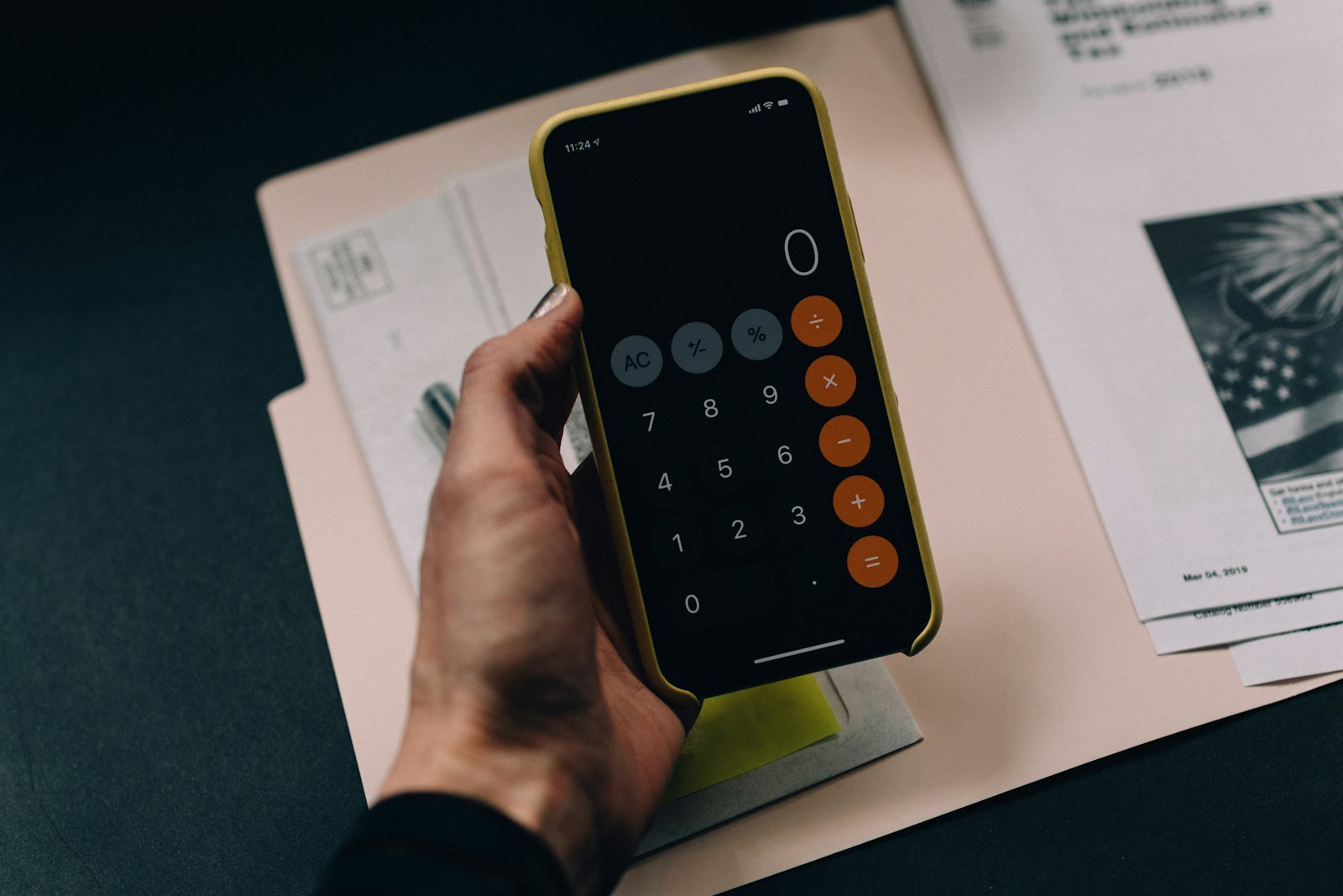 Proposal template pricing: working out a quote on a phone calculator over paperwork