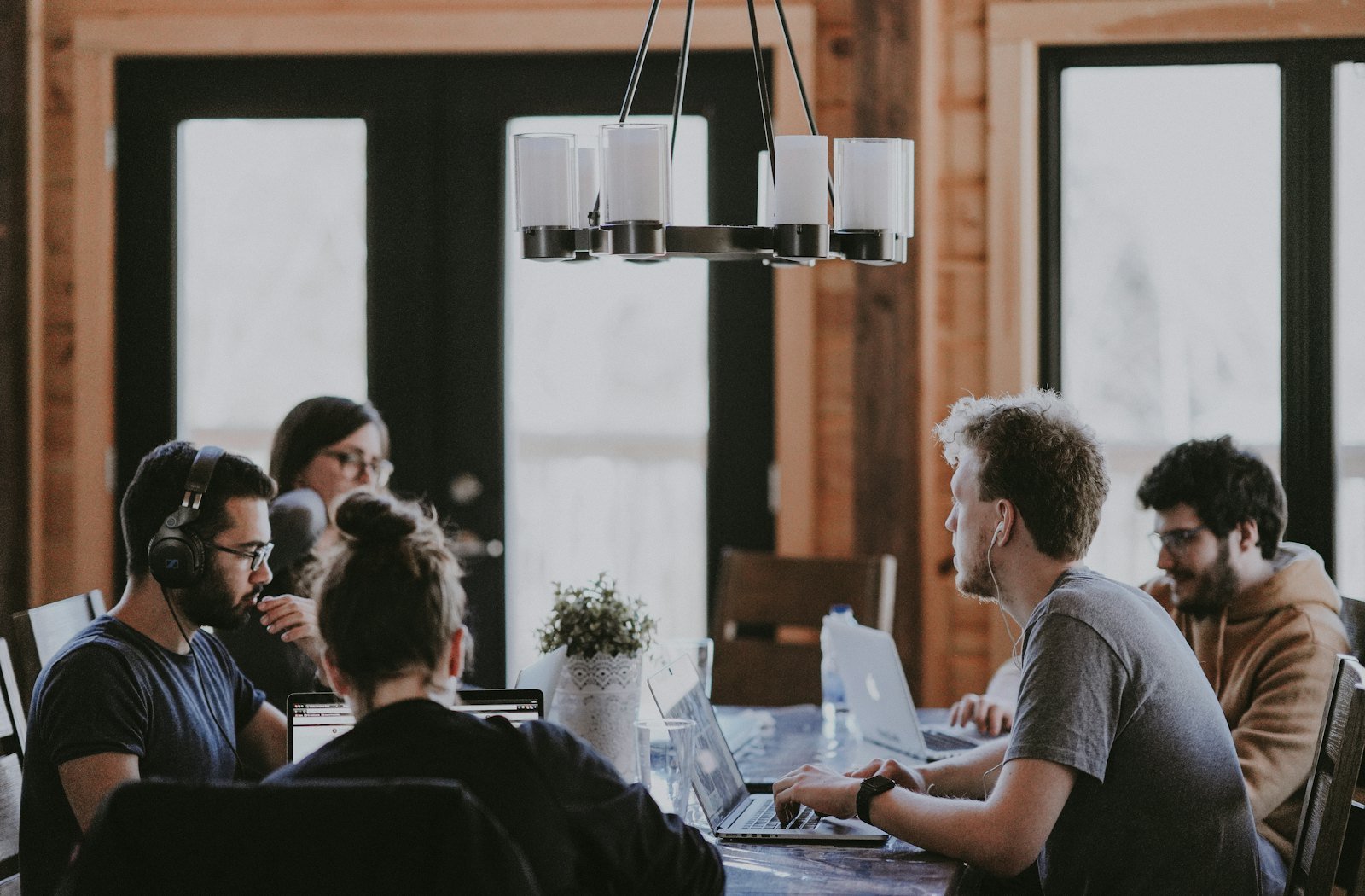 Proposal template review: a team discussing scope and pricing around a table