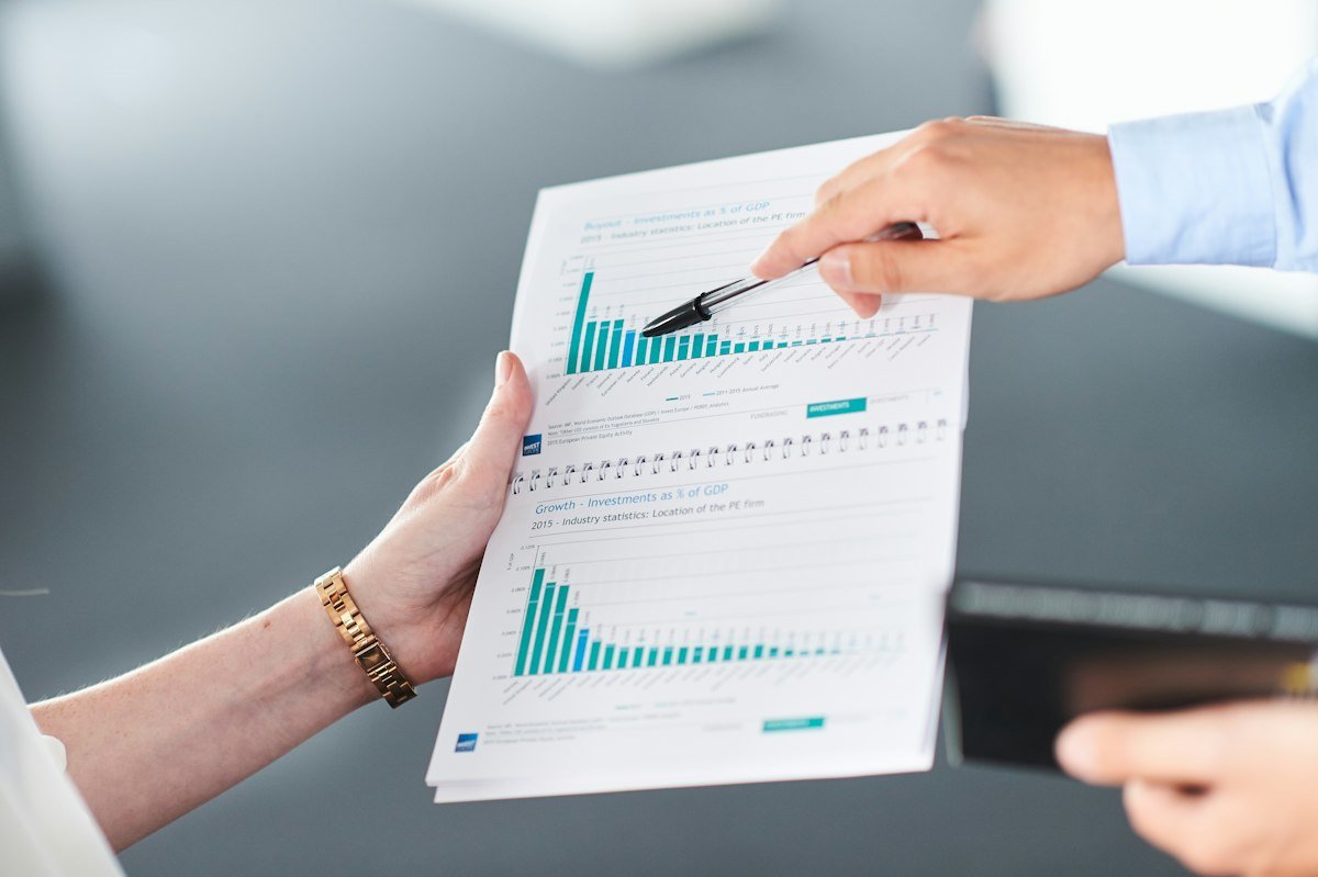 Proposal template layout: two people reviewing a proposal's pricing and timeline pages