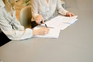 Service contract template: a service business owner and a client reviewing and signing an agreement